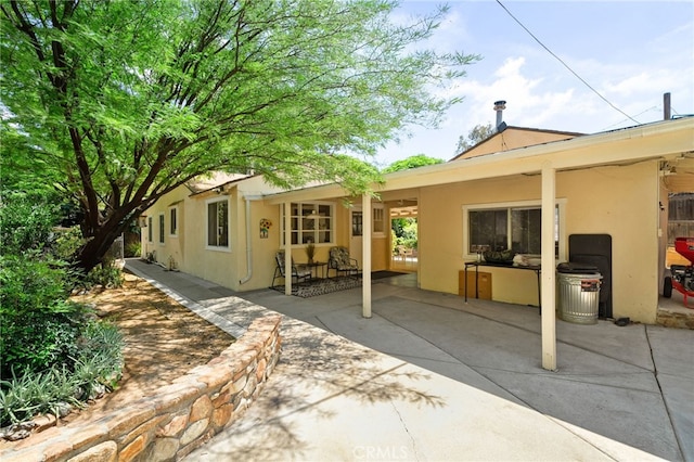 6435 Norwood Ave, Riverside, CA 92505 - back of property featuring stucco siding and a patio area