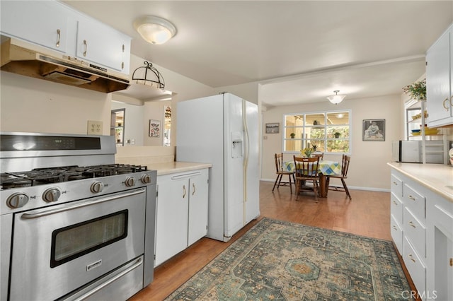 6435 Norwood Ave, Riverside, CA 92505 - kitchen with gas range, under cabinet range hood, white fridge with ice dispenser, light wood-style flooring, and white cabinetry