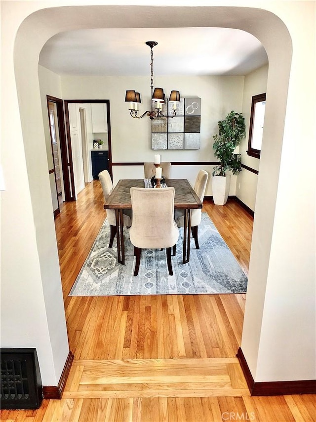 4719 E E Colorado St, Long Beach, CA 90814 - dining room with arched walkways, wood finished floors, and a chandelier