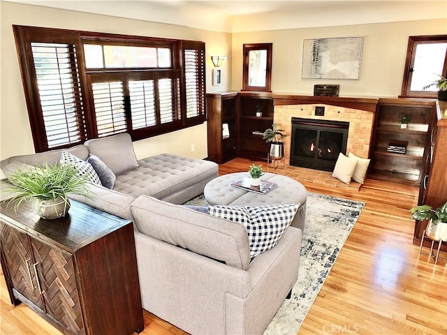 4719 E E Colorado St, Long Beach, CA 90814 - living room featuring healthy amount of natural light, wood finished floors, and a stone fireplace