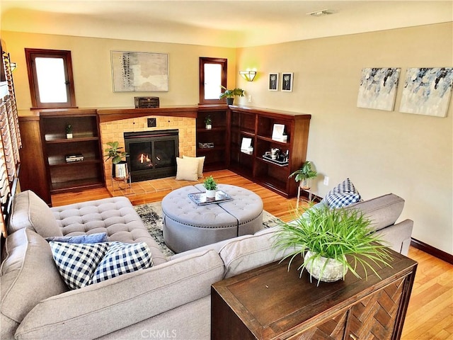 4719 E E Colorado St, Long Beach, CA 90814 - living room with light wood-type flooring and a brick fireplace