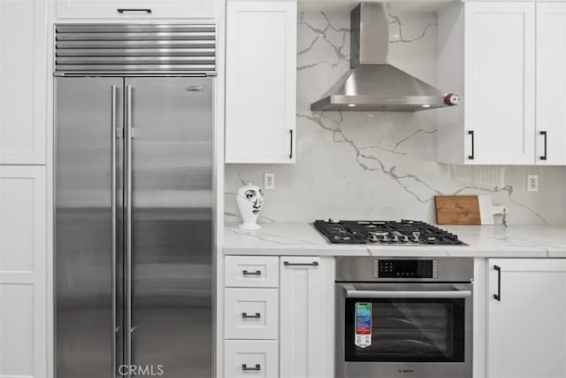 1872 Caminito De La Narcissa, Glendale, CA 91208 - kitchen with appliances with stainless steel finishes, wall chimney exhaust hood, white cabinetry, and light stone countertops