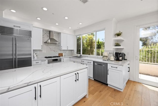 1872 Caminito De La Narcissa, Glendale, CA 91208 - kitchen with wall chimney range hood, stainless steel appliances, white cabinetry, recessed lighting, and light wood-type flooring