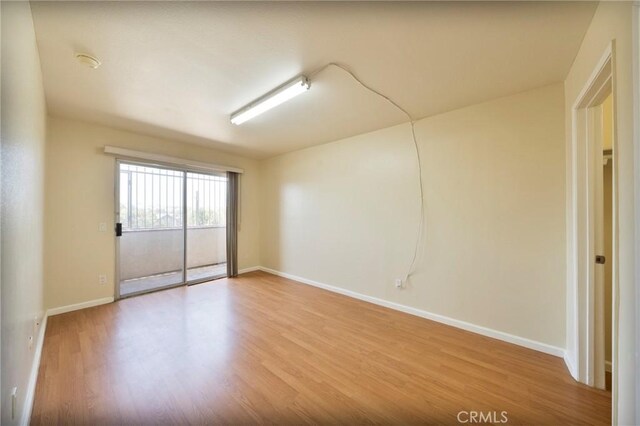 981 S St Andrews Pl Unit 104, Los Angeles, CA 90019 - unfurnished room featuring wood finished floors and a smoke detector