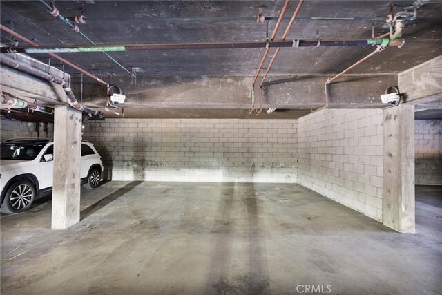 981 S St Andrews Pl Unit 104, Los Angeles, CA 90019 - parking deck featuring concrete block wall