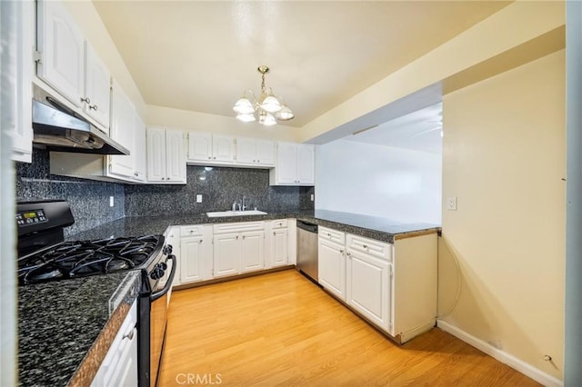 981 S St Andrews Pl Unit 104, Los Angeles, CA 90019 - kitchen with black range with gas cooktop, dishwasher, dark countertops, a chandelier, and under cabinet range hood