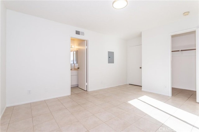 19533 Rinaldi St Unit 48, Porter Ranch, CA 91326 - unfurnished bedroom with electric panel, light tile patterned floors, a closet, and a spacious closet