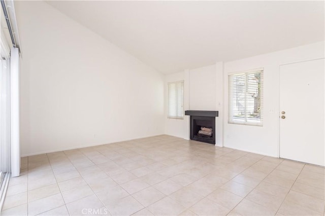 19533 Rinaldi St Unit 48, Porter Ranch, CA 91326 - unfurnished living room with lofted ceiling, a fireplace, and light tile patterned floors