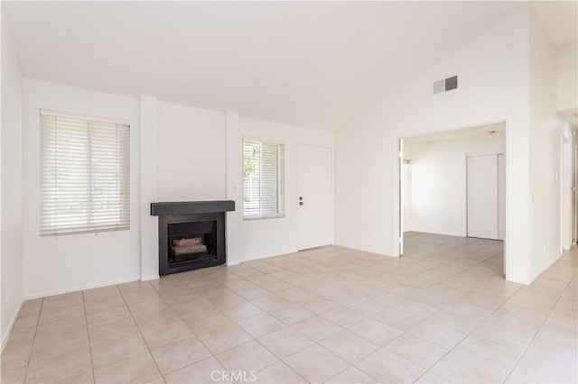 19533 Rinaldi St Unit 48, Porter Ranch, CA 91326 - unfurnished living room featuring a fireplace, light tile patterned floors, and high vaulted ceiling