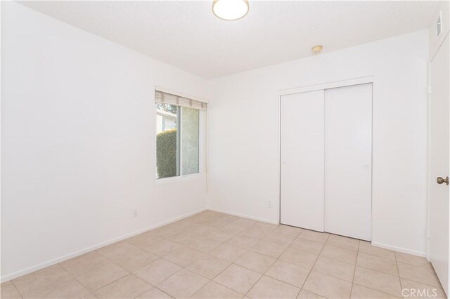 19533 Rinaldi St Unit 48, Porter Ranch, CA 91326 - unfurnished bedroom featuring a closet and baseboards