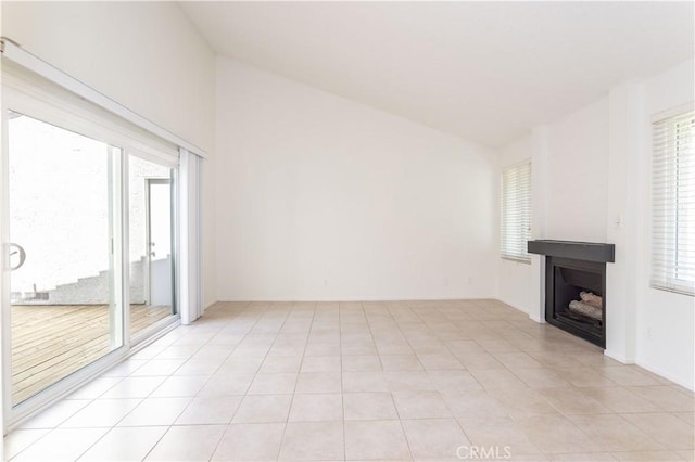 19533 Rinaldi St Unit 48, Porter Ranch, CA 91326 - unfurnished living room with a fireplace, lofted ceiling, and light tile patterned floors