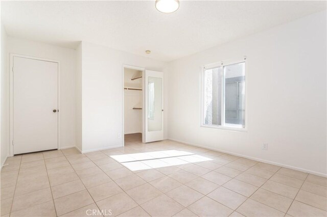 19533 Rinaldi St Unit 48, Porter Ranch, CA 91326 - unfurnished bedroom with light tile patterned floors, a closet, and a spacious closet