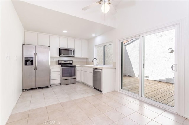 19533 Rinaldi St Unit 48, Porter Ranch, CA 91326 - kitchen featuring stainless steel appliances, light countertops, white cabinets, a ceiling fan, and light tile patterned flooring