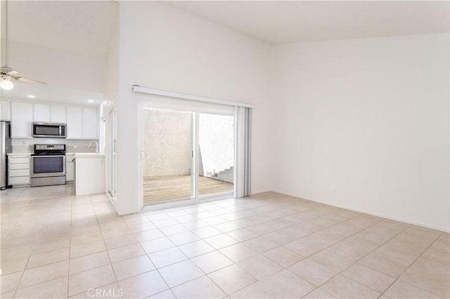 19533 Rinaldi St Unit 48, Porter Ranch, CA 91326 - spare room with a ceiling fan, light tile patterned flooring, and a high ceiling