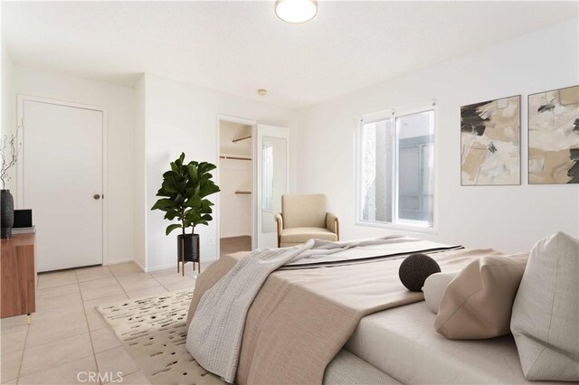 19533 Rinaldi St Unit 48, Porter Ranch, CA 91326 - bedroom featuring light tile patterned flooring, a walk in closet, and a closet