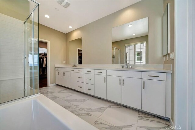 18348 Cachet Way, Canyon Country, CA 91350 - full bath with marble finish floors, a stall shower, double vanity, a walk in closet, and recessed lighting