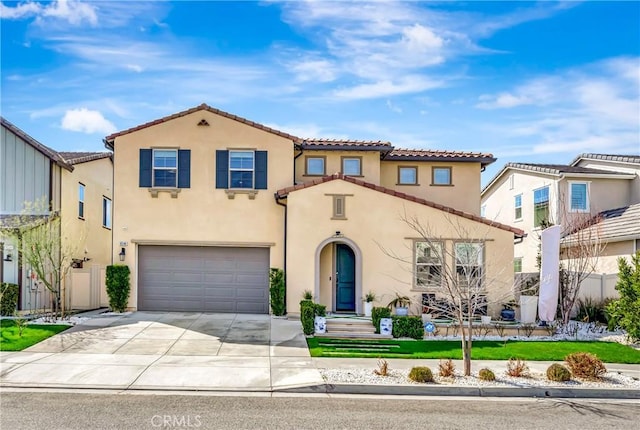 18348 Cachet Way, Canyon Country, CA 91350 - mediterranean / spanish home featuring a tiled roof, an attached garage, concrete driveway, and stucco siding