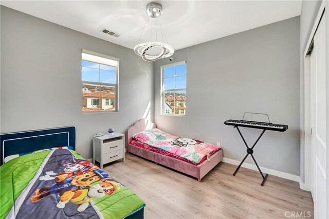 18348 Cachet Way, Canyon Country, CA 91350 - bedroom with light wood finished floors and a chandelier