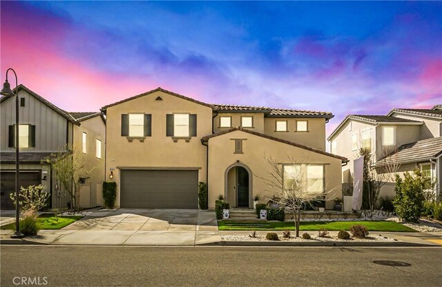 18348 Cachet Way, Canyon Country, CA 91350 - mediterranean / spanish house with a garage, driveway, stucco siding, and a tiled roof