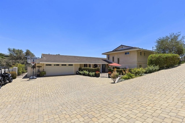 3237 Canonita Dr, Fallbrook, CA 92028 - view of front facade featuring stucco siding, an attached garage, driveway, and a gate