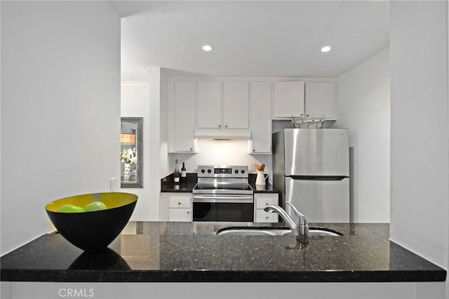 4900 Overland Ave Unit 130, Culver City, CA 90230 - kitchen with stainless steel appliances, under cabinet range hood, white cabinets, dark stone counters, and recessed lighting