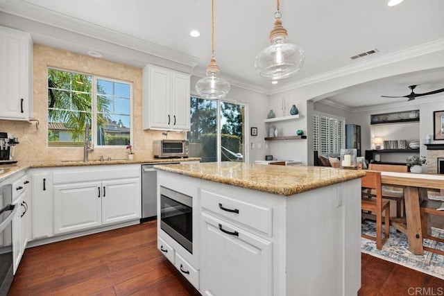 923 Citrine Way, San Marcos, CA 92078 - kitchen with appliances with stainless steel finishes, dark wood-style flooring, backsplash, a kitchen island, and recessed lighting