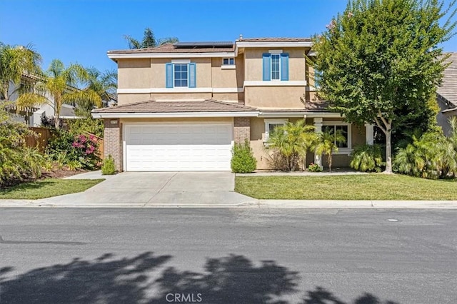 35733 Emily Ave, Murrieta, CA 92563 - view of front of house featuring concrete driveway, an attached garage, solar panels, a front yard, and stucco siding