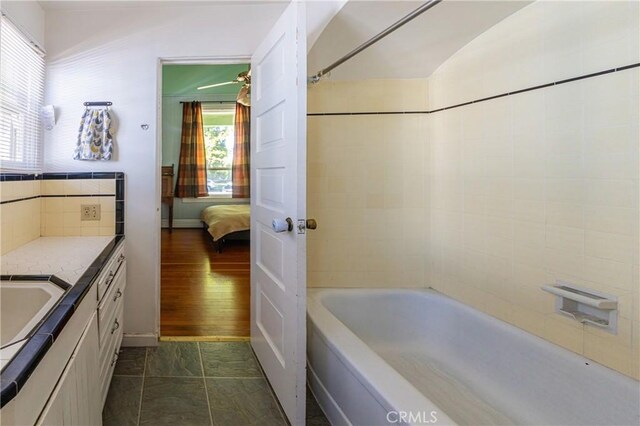 320 W 21st St, Merced, CA 95340 - ensuite bathroom with vanity, decorative backsplash, and bathing tub / shower combination