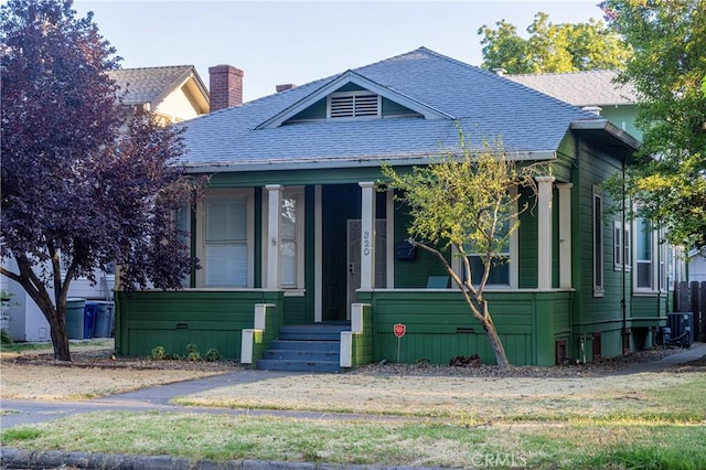 320 W 21st St, Merced, CA 95340 - view of front of house featuring a shingled roof and covered porch