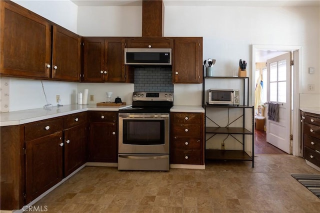 320 W 21st St, Merced, CA 95340 - kitchen with appliances with stainless steel finishes, light countertops, decorative backsplash, and dark brown cabinetry