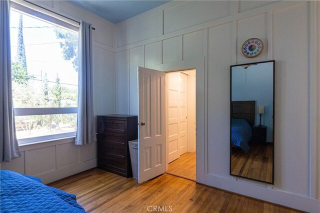 320 W 21st St, Merced, CA 95340 - bedroom with wood finished floors and a decorative wall