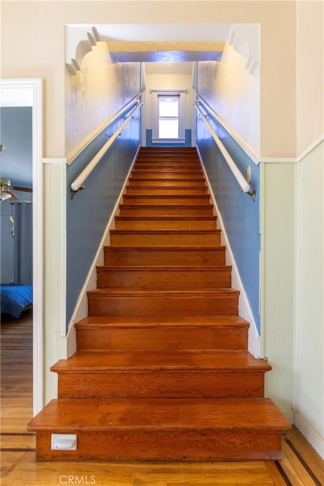 320 W 21st St, Merced, CA 95340 - staircase featuring wood finished floors and a wainscoted wall