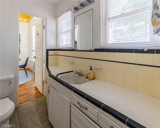 320 W 21st St, Merced, CA 95340 - bathroom with healthy amount of natural light, vanity, tasteful backsplash, and tile patterned flooring