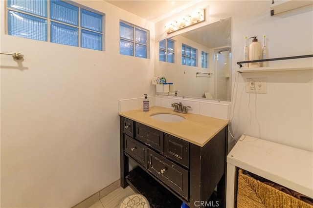 320 W 21st St, Merced, CA 95340 - full bath featuring vanity, a shower with shower door, and tile patterned flooring