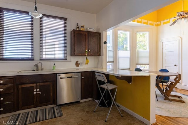 320 W 21st St, Merced, CA 95340 - kitchen with stainless steel dishwasher, healthy amount of natural light, a peninsula, and light countertops