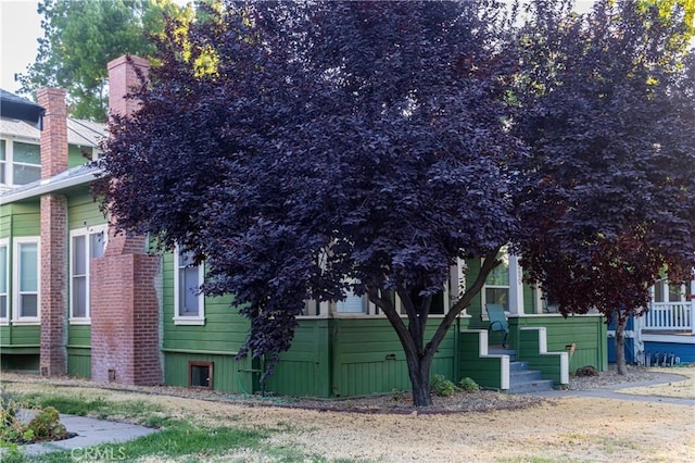 320 W 21st St, Merced, CA 95340 - view of property exterior with a chimney