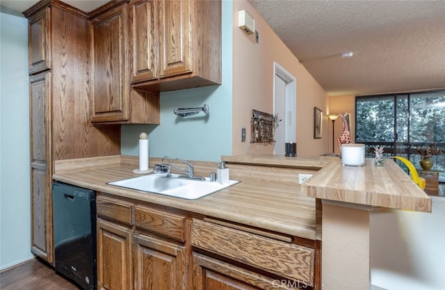 3961 Via Marisol Unit 233, Los Angeles, CA 90042 - kitchen with black dishwasher, a textured ceiling, butcher block countertops, brown cabinets, and dark wood-style flooring