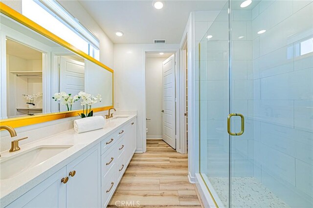 27505 Illumination Ct, Valencia, CA 91381 - bathroom with double vanity, a stall shower, wood finished floors, and recessed lighting