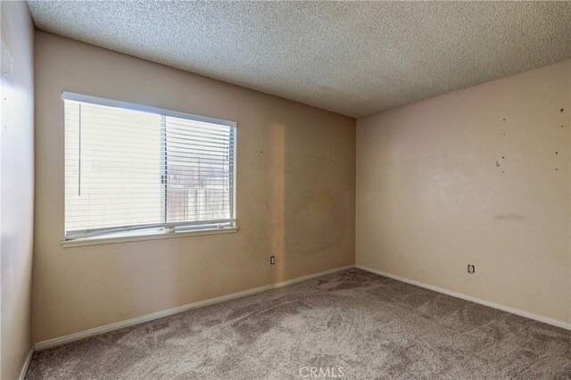 5943 Sky Meadow St, Jurupa Valley, CA 92509 - empty room with carpet floors and a textured ceiling
