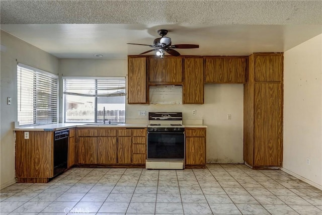 5943 Sky Meadow St, Jurupa Valley, CA 92509 - kitchen with white gas stove, black dishwasher, brown cabinetry, ceiling fan, and a textured ceiling