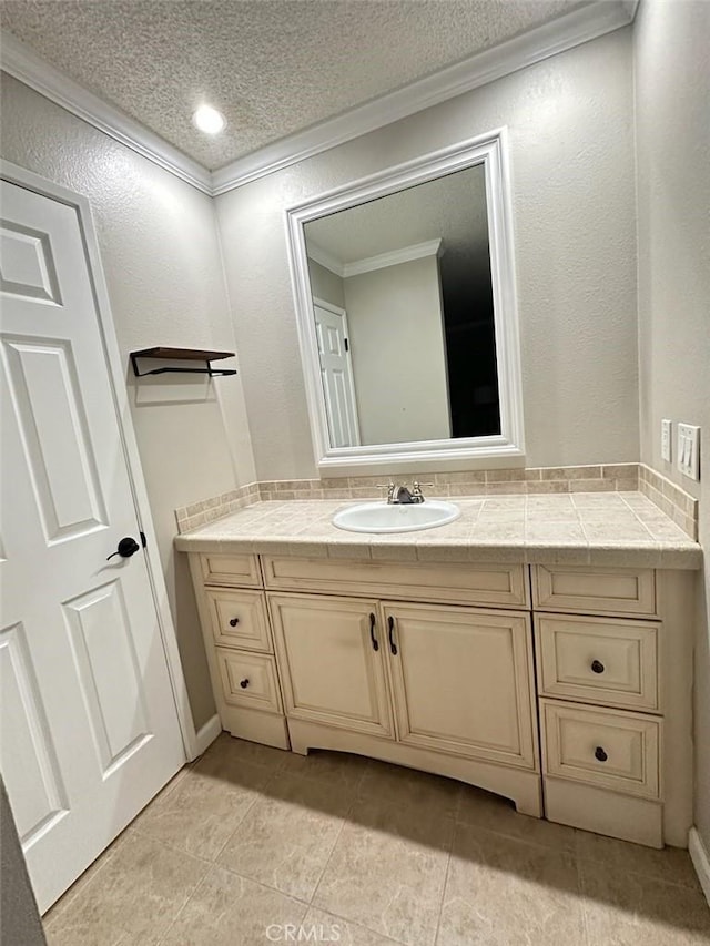 2200 Woodside Ln Unit 2, Sacramento, CA 95825 - bathroom with crown molding, vanity, a textured ceiling, a textured wall, and tile patterned flooring