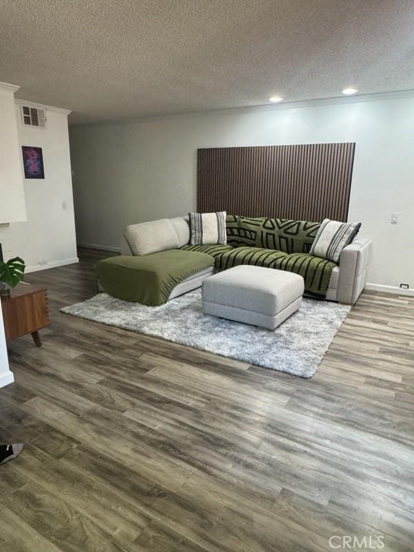 2200 Woodside Ln Unit 2, Sacramento, CA 95825 - living area featuring a textured ceiling, wood finished floors, and recessed lighting