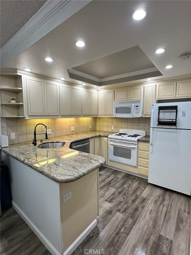 2200 Woodside Ln Unit 2, Sacramento, CA 95825 - kitchen with white appliances, a raised ceiling, a peninsula, dark wood-style floors, and crown molding