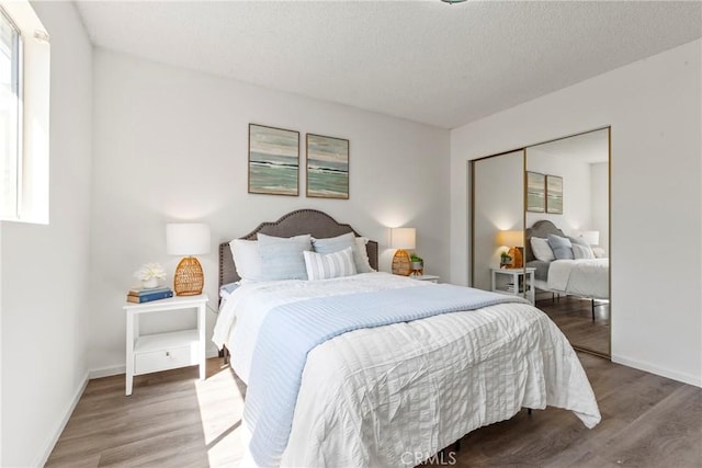 244 Santa Fe Ave, Pismo Beach, CA 93449 - bedroom with wood finished floors, multiple windows, and a closet