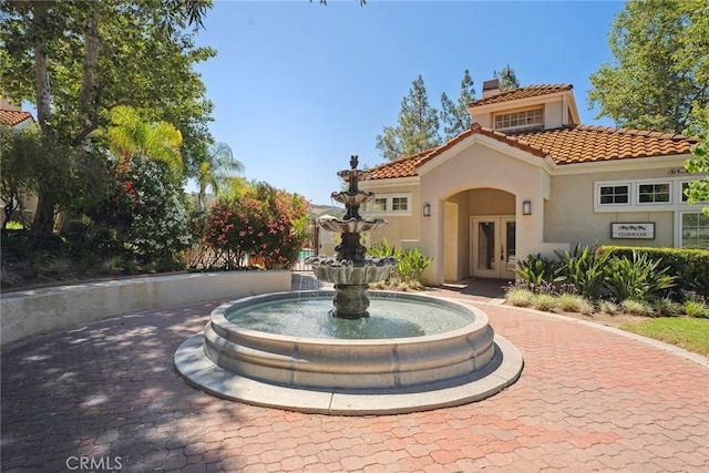 4240 Lost Hills Rd Unit 2205, Calabasas, CA 91301 - view of front of home with french doors, a chimney, a tile roof, and stucco siding