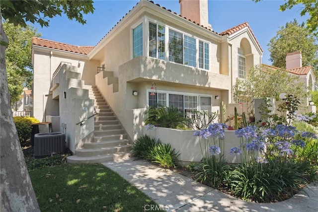 4240 Lost Hills Rd Unit 2205, Calabasas, CA 91301 - view of front of property with a chimney, stairway, a tiled roof, and stucco siding