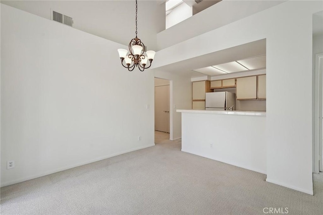 4240 Lost Hills Rd Unit 2205, Calabasas, CA 91301 - unfurnished living room with light carpet, a chandelier, and a high ceiling