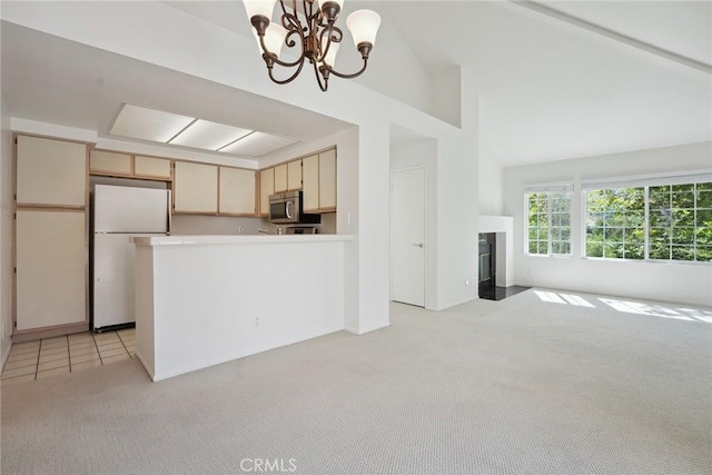 4240 Lost Hills Rd Unit 2205, Calabasas, CA 91301 - kitchen with freestanding refrigerator, stainless steel microwave, light carpet, open floor plan, and a chandelier