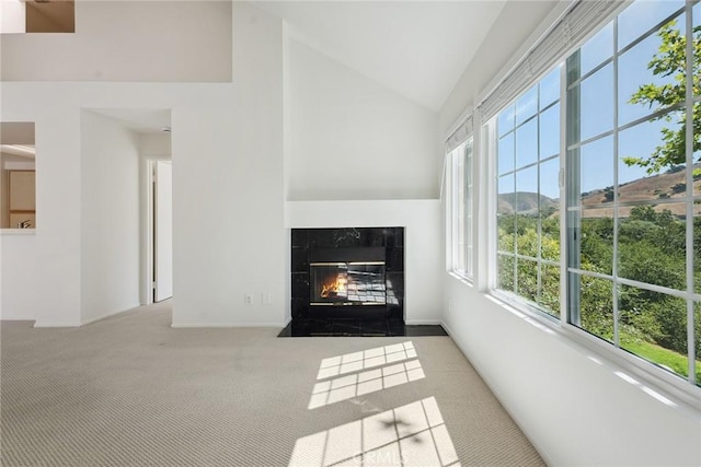 4240 Lost Hills Rd Unit 2205, Calabasas, CA 91301 - unfurnished living room featuring healthy amount of natural light, carpet flooring, a fireplace, and high vaulted ceiling