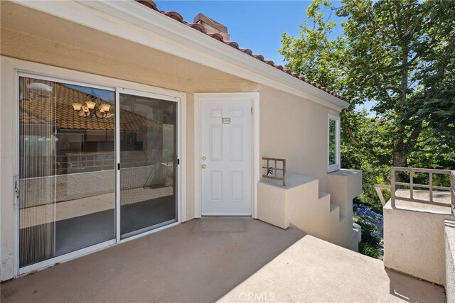 4240 Lost Hills Rd Unit 2205, Calabasas, CA 91301 - doorway to property featuring a tile roof and stucco siding